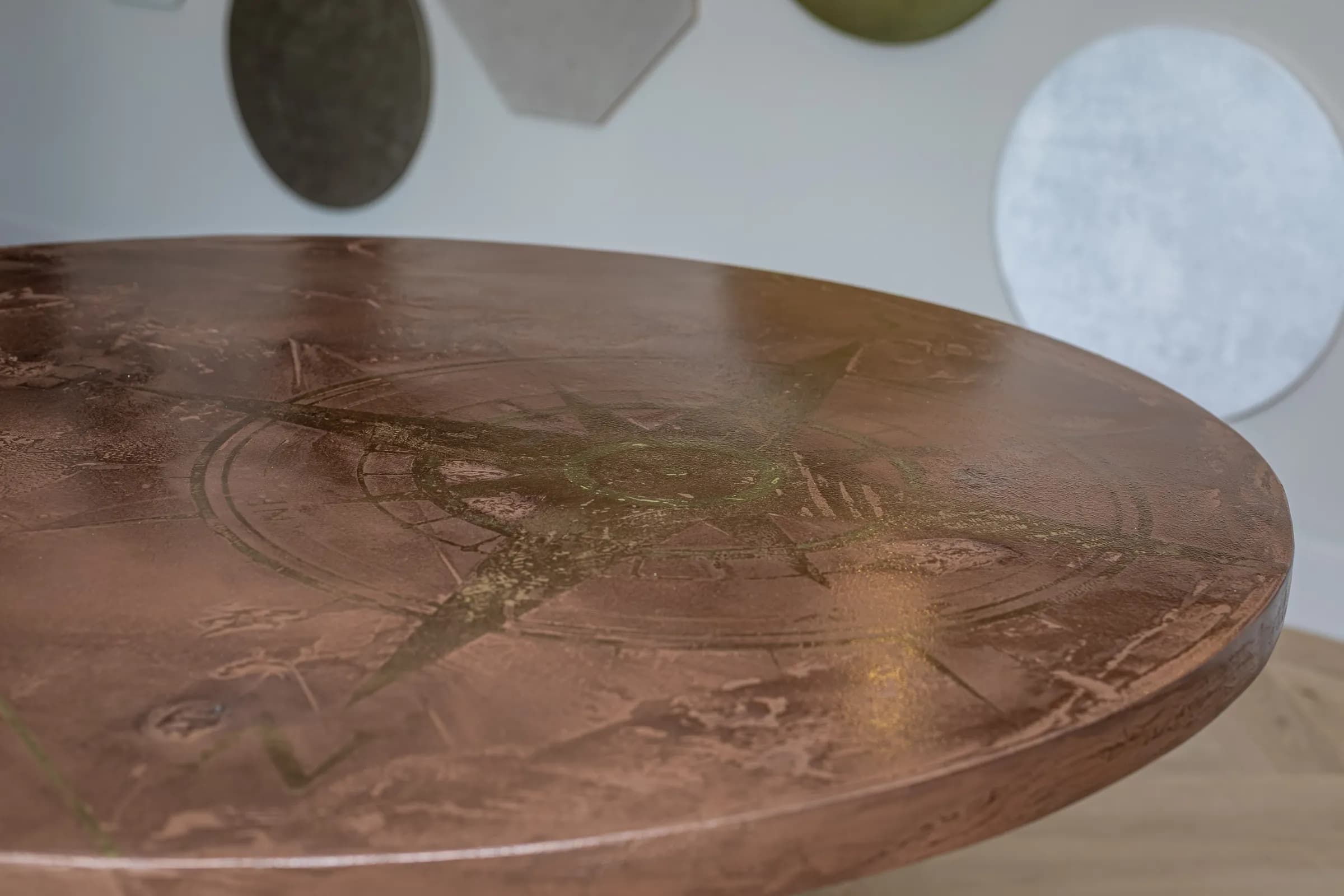 Close-up of a round table top with a copper coloured patina