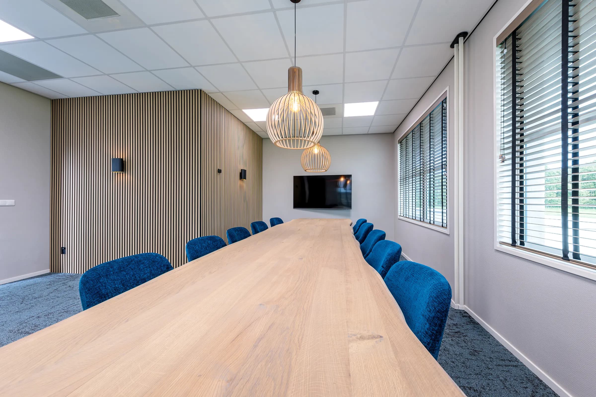 Long meeting table on two black cast iron columns without chairs at Wiz Arts